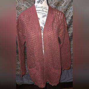 Womens cableknit cardigan sweater.